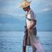 Local fishermen from Inle Lake are known for their distinctive one-leg rowing style. Standing at the stern on one leg, they wrap the other leg around the oar.