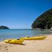 Kayaking the pristine coastal waters of the Abel Tasman National Park is a popular vacation activity on the South Island of New Zealand.