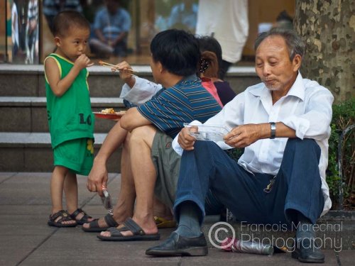 Shanghai is hot and very humid in summertime. Tourists and locals alike often look for some shade to rest. One can also sit right outside a retail shop which continuously blows cold air.