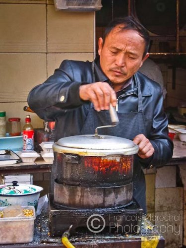 Street market vendor cooking outdoor.